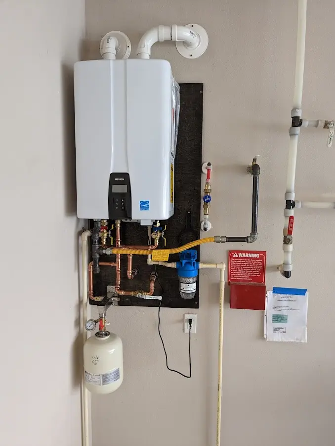 Professional plumber installing copper piping in a Heber-Overgaard home